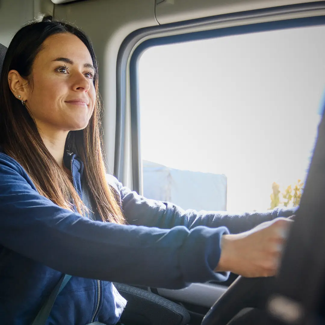 Office employee monitoring fleet data on a computer.