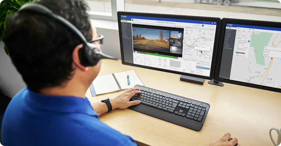 Fleet manager reviewing ISAAC InView AI camera footage and telematics data on dual monitors