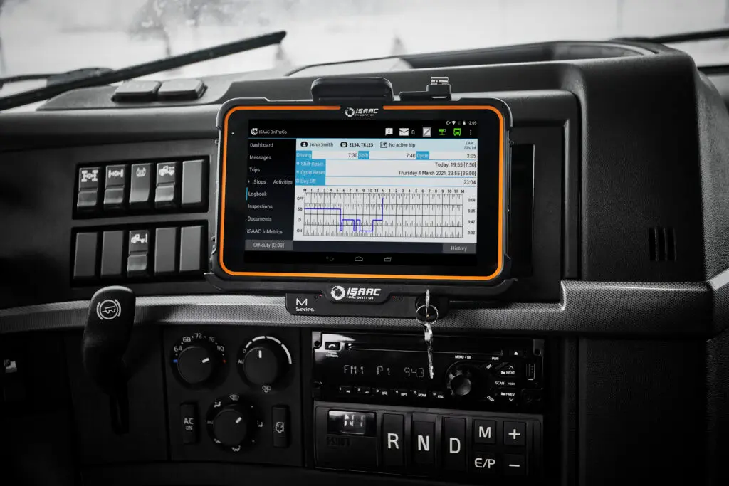 Mounted ISAAC tablet on truck dashboard displaying electronic logbook (ELD) hours-of-service graph.