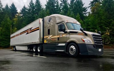May Trucking Company Freightliner truck representing the fleet's selection of ISAAC Instruments for next-generation in-cab technology and telematics.